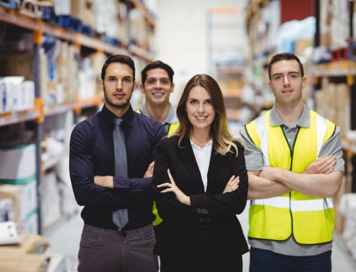 Portrait of warehouse manager and workers in warehouse